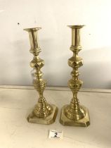 A PAIR OF VICTORIAN BRASS CANDLESTICKS, 30 CMS.