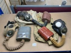THREE GAS MASKS; TWO BY BW&M WITH TWO BAGS