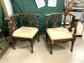 PAIR OF 19TH-CENTURY WALNUT CARVED ITALIAN CORNER CHAIRS WITH GRIFFIN SPATS AND CHERUB CENTER