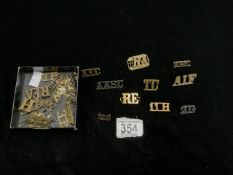 ROYAL ENGINEERS BRASS SHOULDER BADGE AND A QUANTITY OF OTHERS.