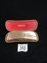 A HOHNER COMET HARMONICA IN CASE.