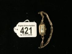 A LADIES SWISS 9CT CASED WRIST WATCH WITH FLEXI STRAP.