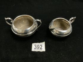 EDWARDIAN HALLMARKED SILVER TWO HANDLED HALF FLUTED SUGAR BOWL AND A MATCHING CREAM JUG,