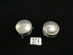 TWO HALLMARKED SILVER CIRCULAR RING BOXES, ONE WITH ENGRAVED LID RAISED ON PAD FEET, BIRMINGHAM