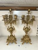 A PAIR OF ORNATE BRASS FIVE BRANCH CANDLEABRA, 46 CMS.