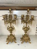 A PAIR OF ORNATE BRASS FIVE BRANCH CANDLEABRA, 46 CMS.