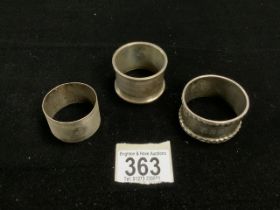 THREE HALLMARKED SILVER NAPKIN RINGS, 82 GMS.