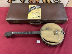 A VINTAGE BANJO IN LEATHER CASE - RETAILER A,. MONTGOMERY - STAINES.