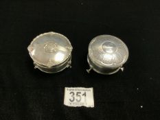 TWO HALLMARKED SILVER CIRCULAR RING BOXES, 1 WITH EMBOSSED COAT OF ARMS, RAISED ON PAD FEET,
