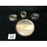 THREE HALLMARKED SILVER NAPKIN RINGS AND A GERMAN CIRCULAR DISH STAMPED 925, 200 GMS.