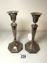 A PAIR OF OCTAGONAL HALLMARKED SILVER CANDLESTICKS, SHEFFIELD 1916, HARRISON BROS & HOWSON, 20 CMS.