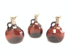 THREE COLOURED GLASS DECANTERS WITH HALLMARKED SILVER COLLAR'S AND STOPPERS BY ATKIN BROTHERS; DATED