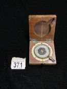 A 1st WORLD WAR MILITARY COMPASS IN A MAHOGANY CASE; STAMPED WITH THE ARROW AND BARKER & SONS MAKERS