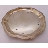 A hallmarked silver card tray with scalloped border on three ball feet, approx total weight 158g,