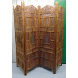 An oriental pierced and hinged four panel wooden screen, each panel 183.5 x 50 x 2cm