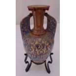 An early 20th century Cypriot ceramic vase, oval form with pierced sides on metal stand, 42cm (h)