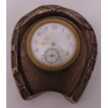 A desk clock of circular form mounted in a hallmarked silver horseshoe frame, Birmingham 1902