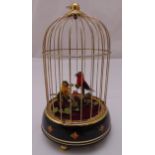 An automaton of two birds in a cage on raised circular base on three bun feet, 24.5cm (h)