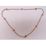 18ct multi coloured gold and carved pink stone necklace, approx total weight 56.9g