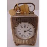 A rectangular hallmarked silver carriage clock, engine turned, white enamel dial and Roman