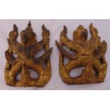 A pair of Far Eastern carved and gilded wall carvings in the form of mythological deities, 19.5 x