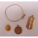 A quantity of 9ct gold jewellery to include a bangle, two Saint Christopher pendants and a pendant