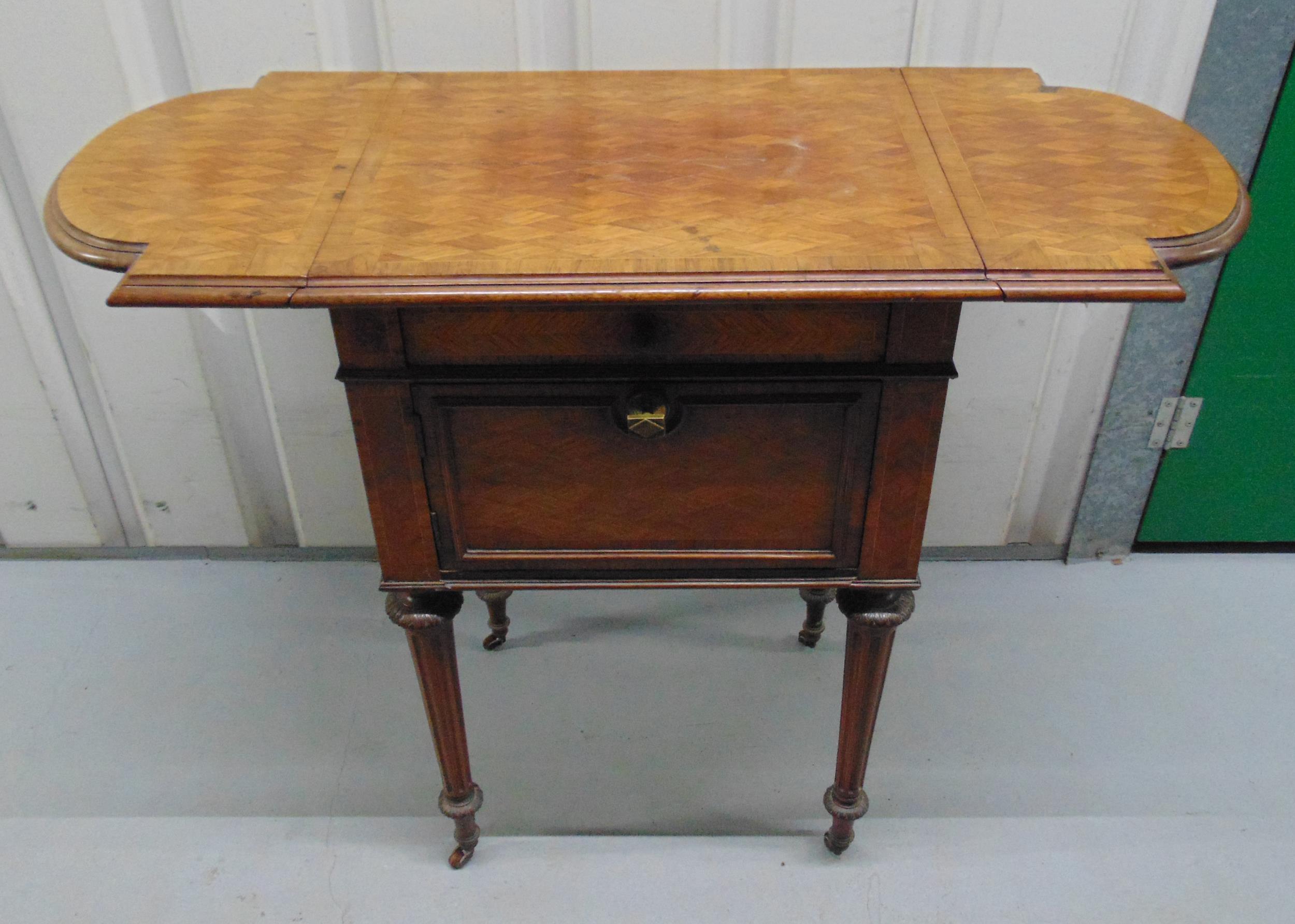 A mahogany inlaid drop flap tea table on tapering cylindrical legs with castors, 72 x 92 x 39.5cm