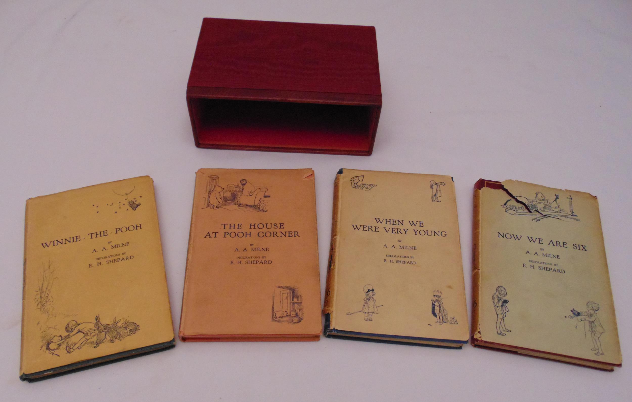 A.A. Milne a set of four first edition hard bound books with original dust jackets to include Winnie