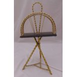 A brass magazine rack of simulated bamboo form with carrying handle, 70 x 35 x 30cm