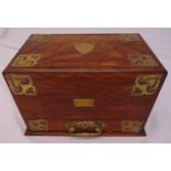 A Victorian rectangular oak and brass bound writing box with a revolving action revealing fitted