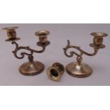 A pair of white metal two light candelabra on raised circular bases, 14cm (h) one A/F