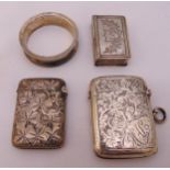 A quantity of hallmarked silver to include a pill box, two vesta cases and a napkin ring, approx