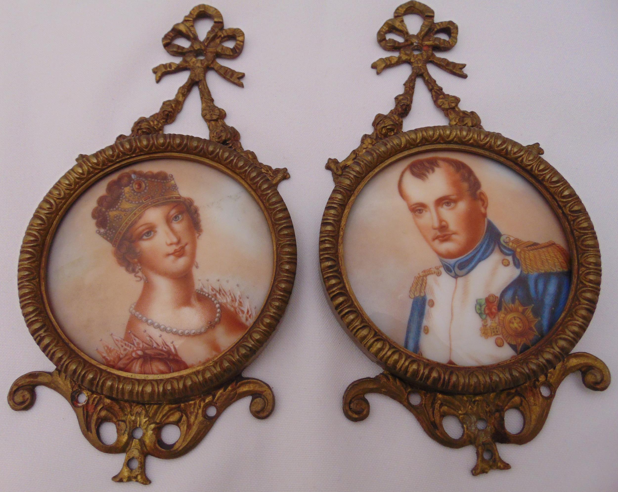 A pair of gilded metal wall plaques with images of Napoleon and Josephine, 20 x 10cm