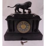 A late Victorian black slate mantle clock of architectural form with black dial and Roman