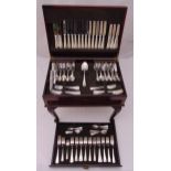 A canteen of silver plated flatware in mahogany free standing cabinet with tooled leather inset top