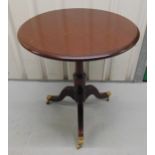 A circular mahogany side table on three outswept legs with castors, 71.5 x 64.5cm