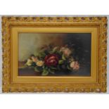 A framed oil on panel still life of roses, 24 x 40.5cm