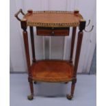 A mahogany inlaid trolley table with gilded metal gallery and single drawer on cylindrical legs