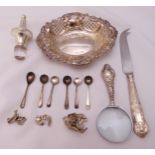 A quantity of silver to include a bonbon dish, condiment spoons, a cheese knife, a magnifying glass,