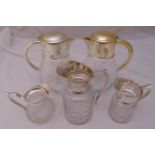 Two glass lemonade jugs with silver plated covers, three cut glass graduated jugs with silver plated