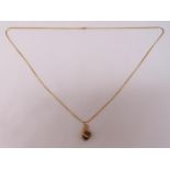 9ct yellow gold and tigers eye pendant in the form of an eagle claw on a 9ct gold necklace, approx