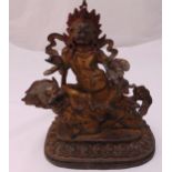 A gilded bronze Buddha seated on a stylised lion on raised rounded rectangular base, 27 x 24cm