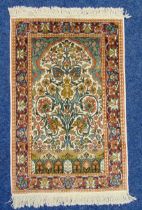 A Persian silk prayer rug with tree of life within stylised floral borders, 103 x 62cm