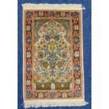 A Persian silk prayer rug with tree of life within stylised floral borders, 103 x 62cm