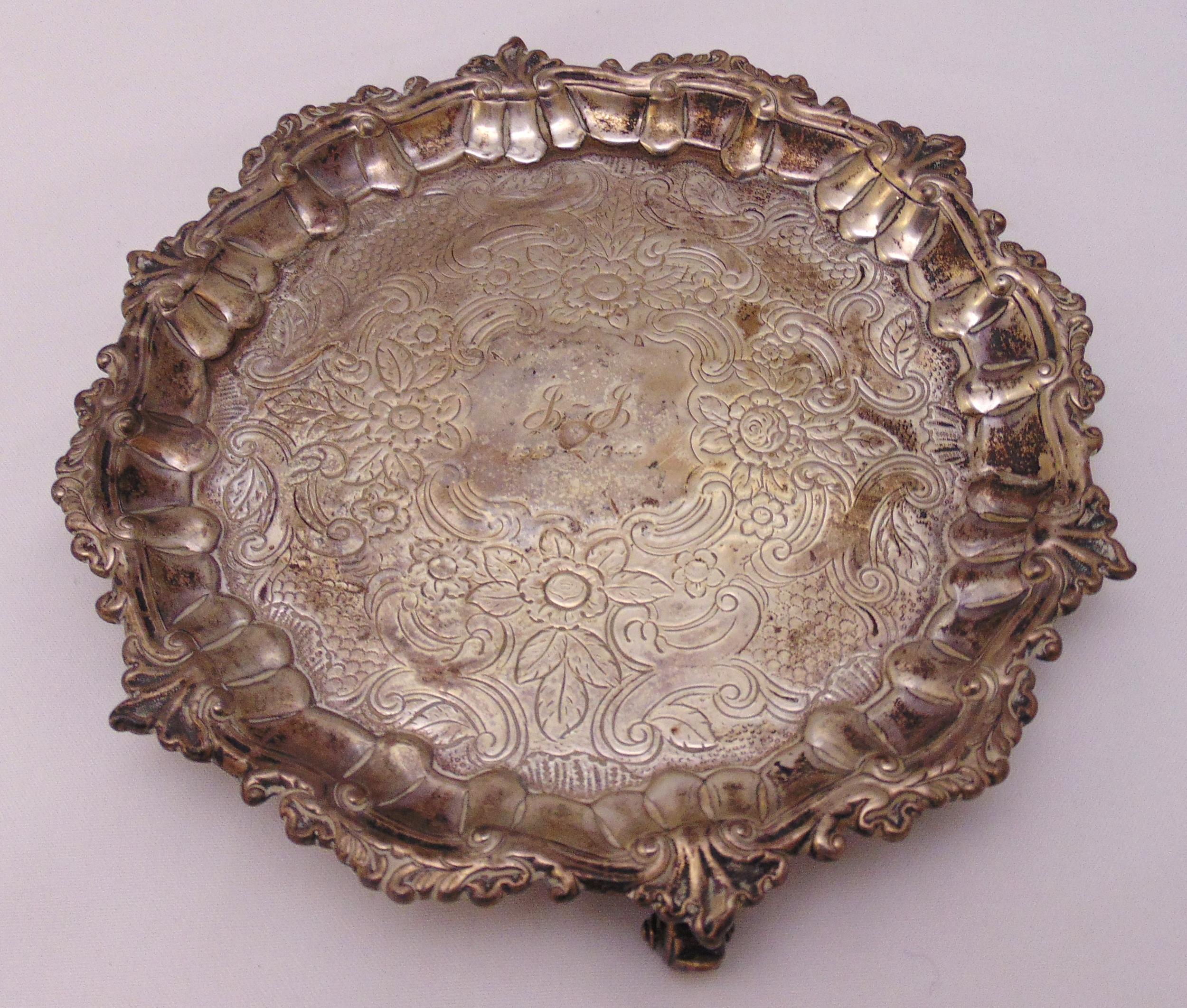 A George III hallmarked silver salver, shell and leaf scroll border, later chased floral and