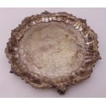 A George III hallmarked silver salver, shell and leaf scroll border, later chased floral and