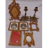 A quantity of gilded metal frames, a pair of table candlesticks and two framed miniatures (8)