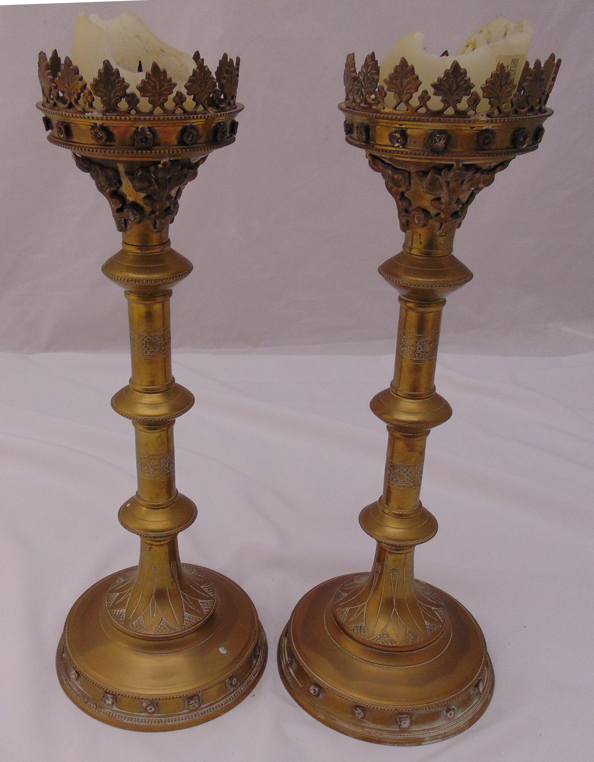 A pair of Victorian ecclesiastical brass candlesticks, cylindrical knopped form on raised circular