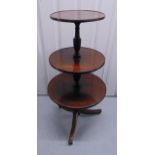 An early 20th century mahogany circular graduated three tier tea table on three outswept legs, 121 x
