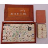 A wooden cased Mah-jong set to include polychromatic counters